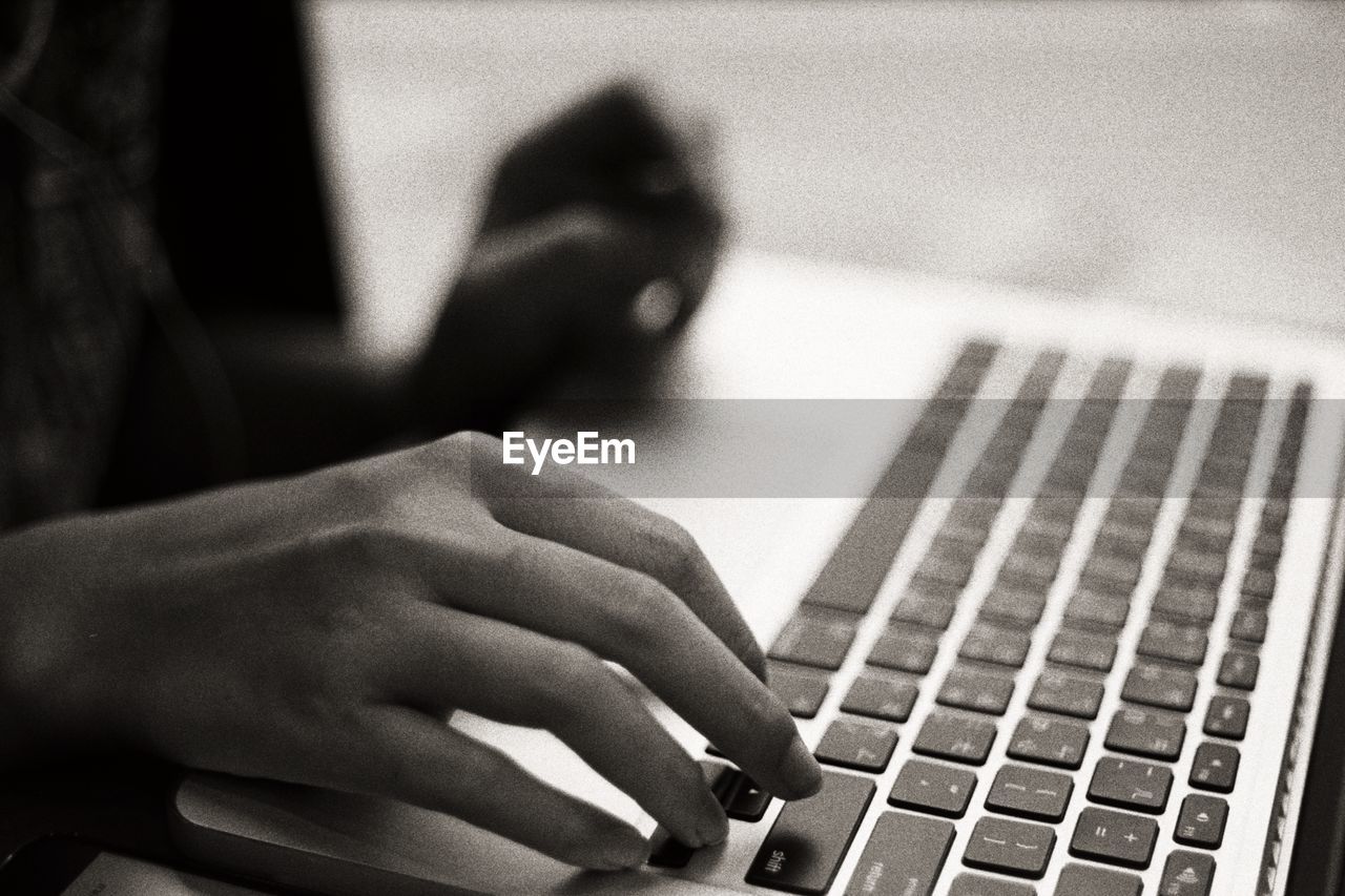 Close-up of woman using computer