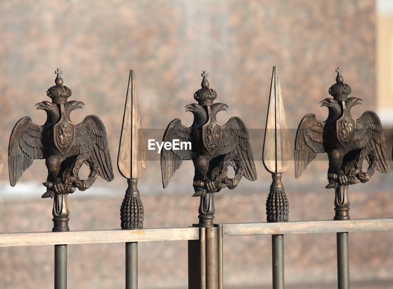 CLOSE-UP OF METAL FENCE AGAINST RAILING