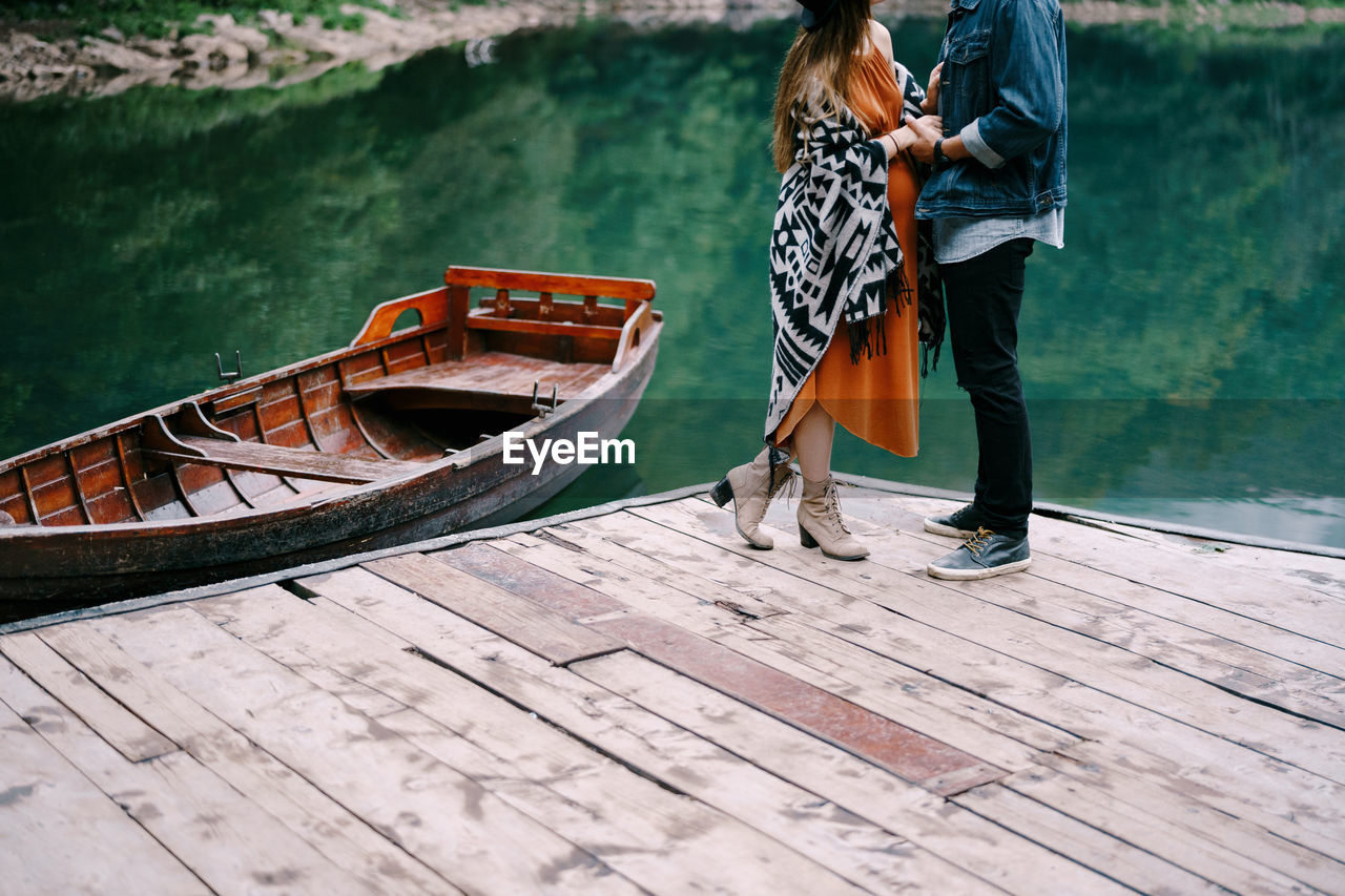 Woman standing on boat in lake