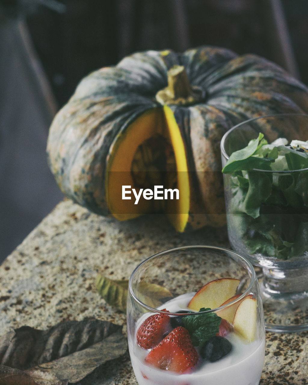 High angle view of fruits with drink and pumpkin on table