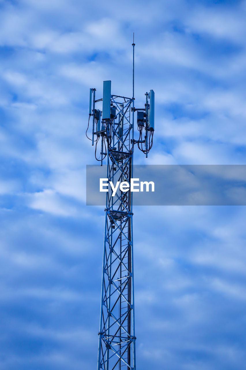 Low angle view of communications tower against sky