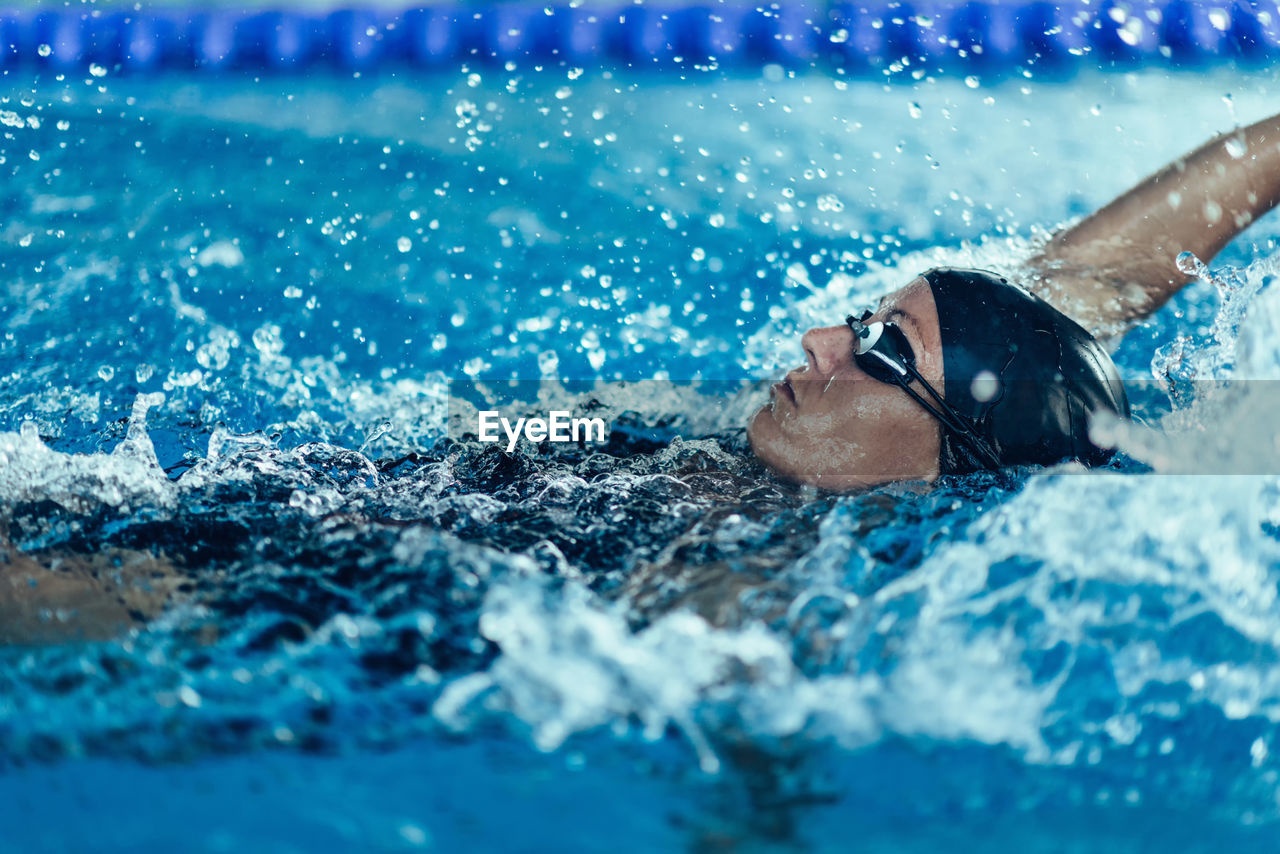 Woman swimming in pool during competition