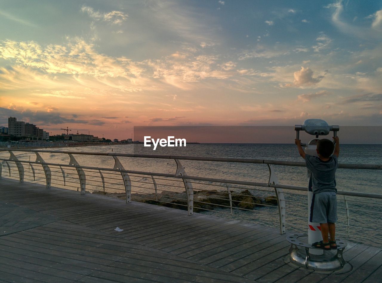 WOMAN LOOKING AT SUNSET