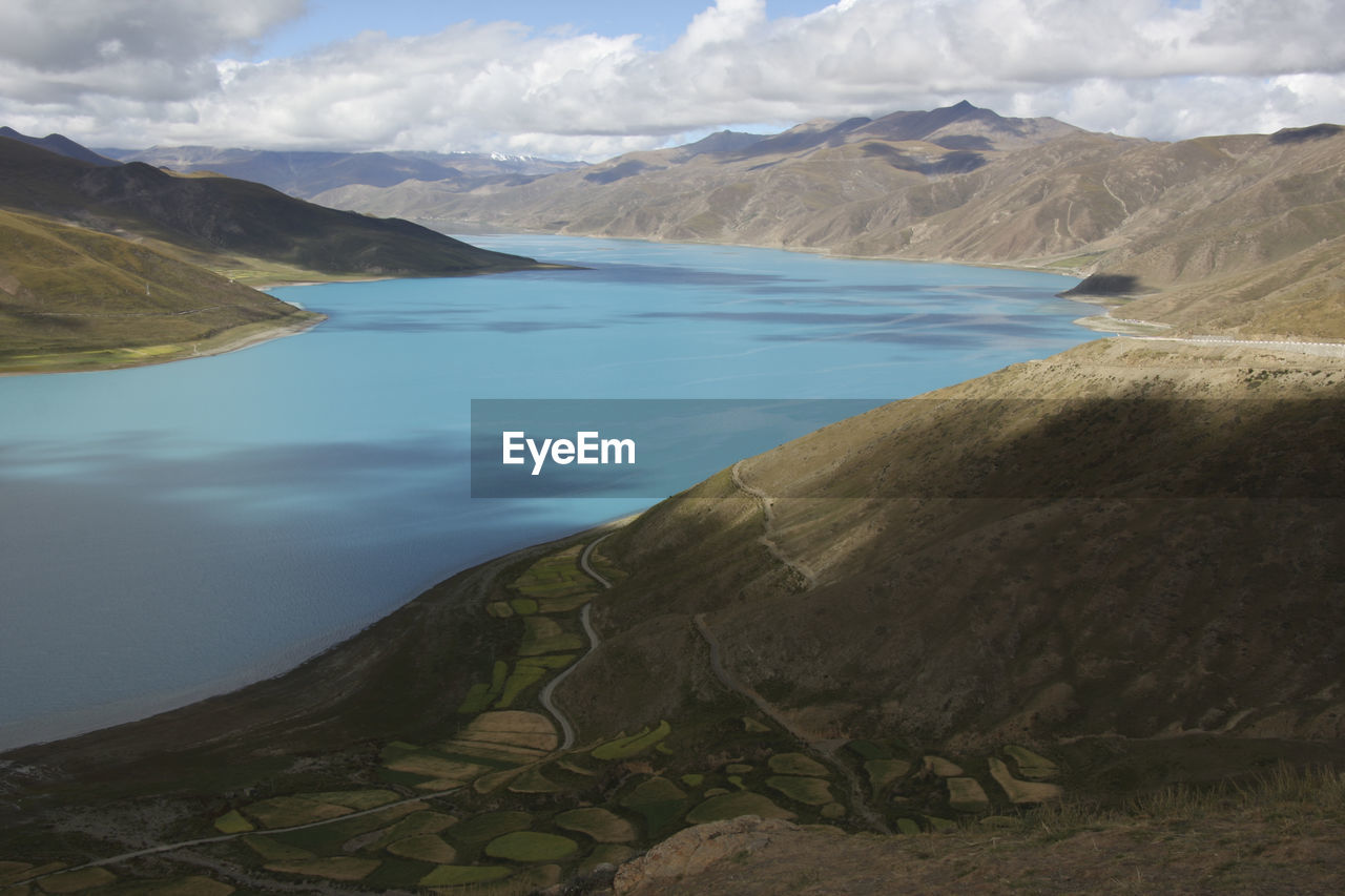 Scenic view of lake and mountains against sky