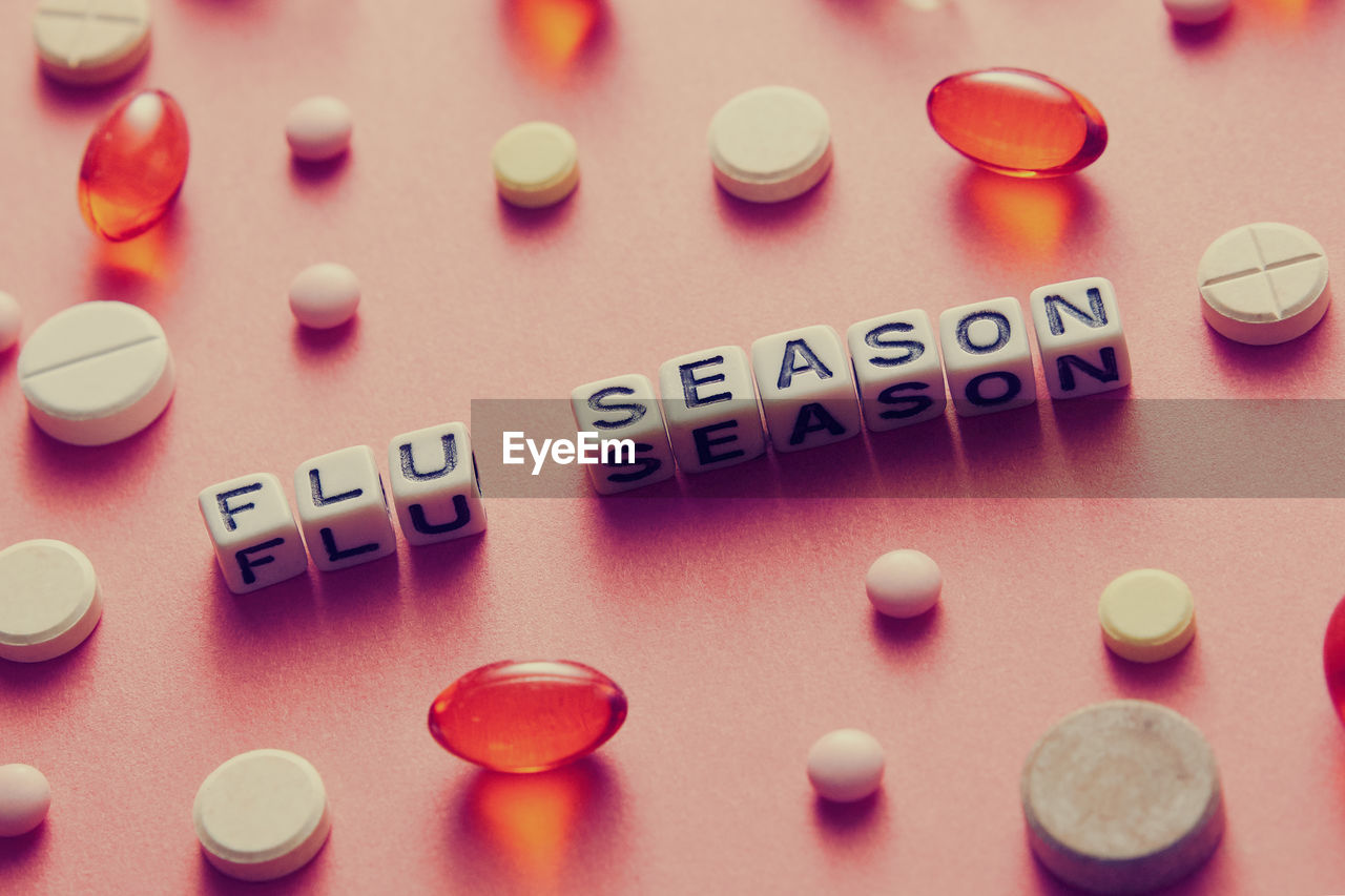 High angle view of beads with pills on table