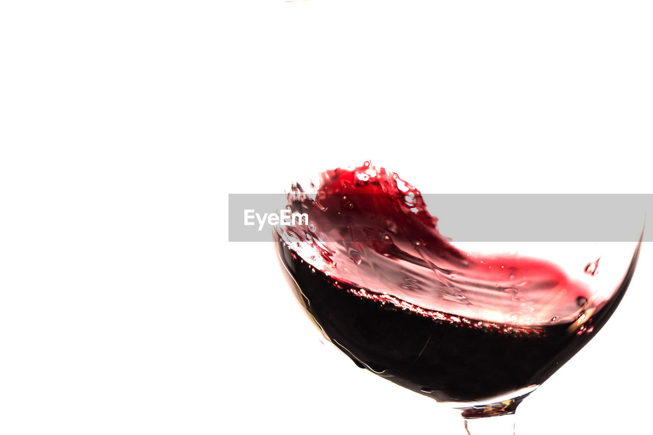 Close-up of red wine against white background