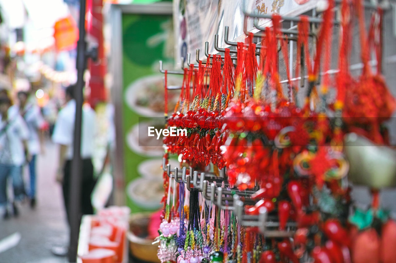Close-up of craft products hanging at market stall