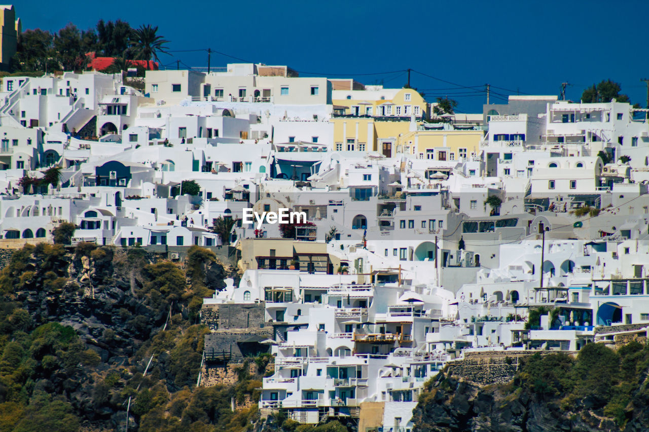 HIGH ANGLE VIEW OF RESIDENTIAL BUILDINGS AGAINST SKY