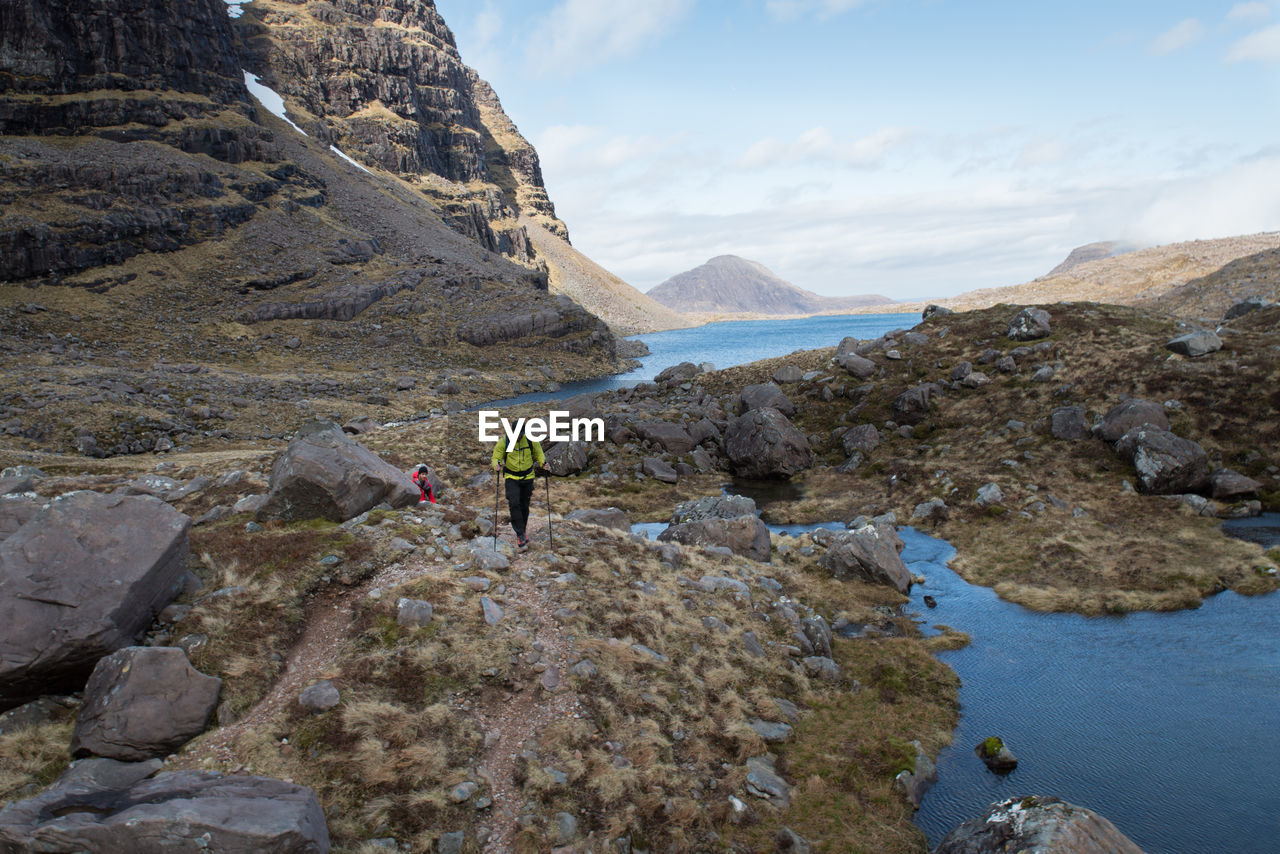 High angle view of male hikers hiking on mountain