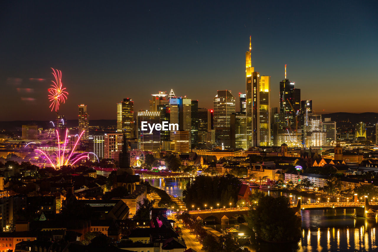 Fireworks mainfest frankfurt in front of illuminated city skyline