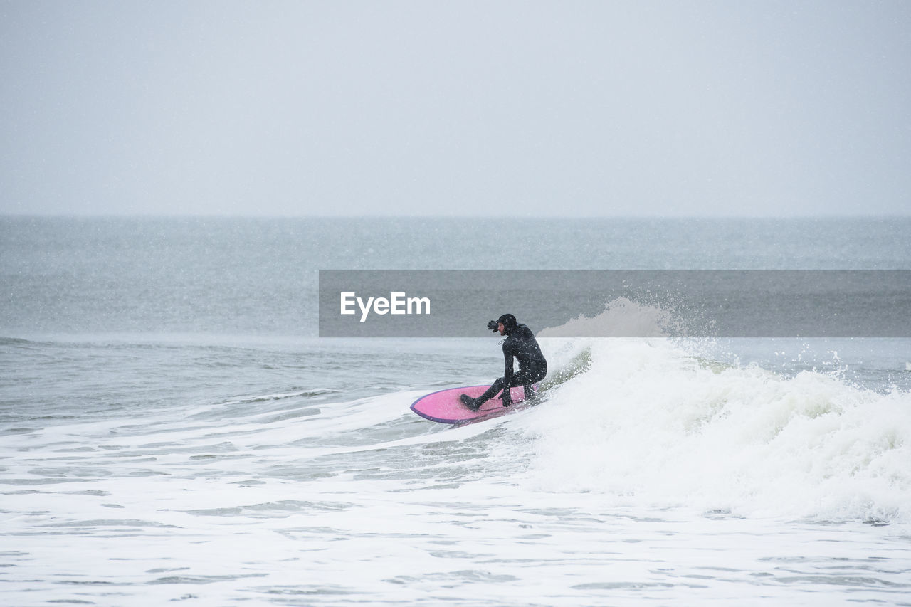 Man surfing during winter snow