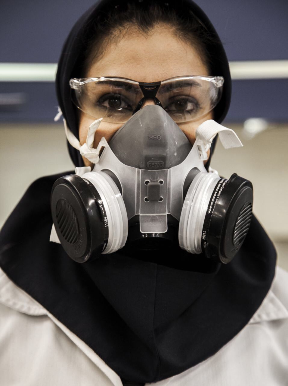 Close-up portrait of woman in gas mask at laboratory