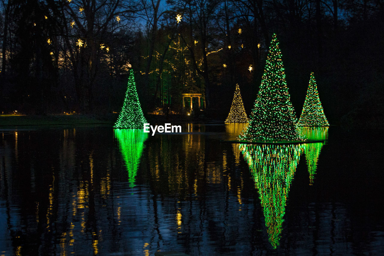 TREES REFLECTING IN WATER