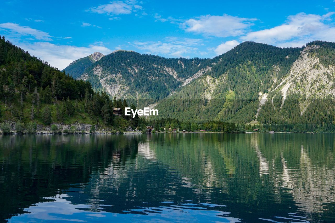 Scenic view of lake and mountains against sky