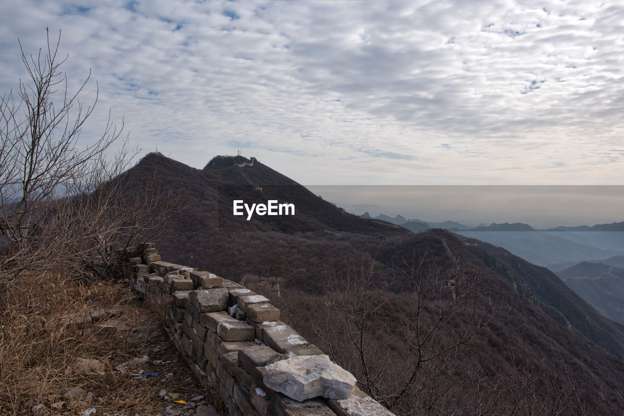 Scenic view of mountain against cloudy sky