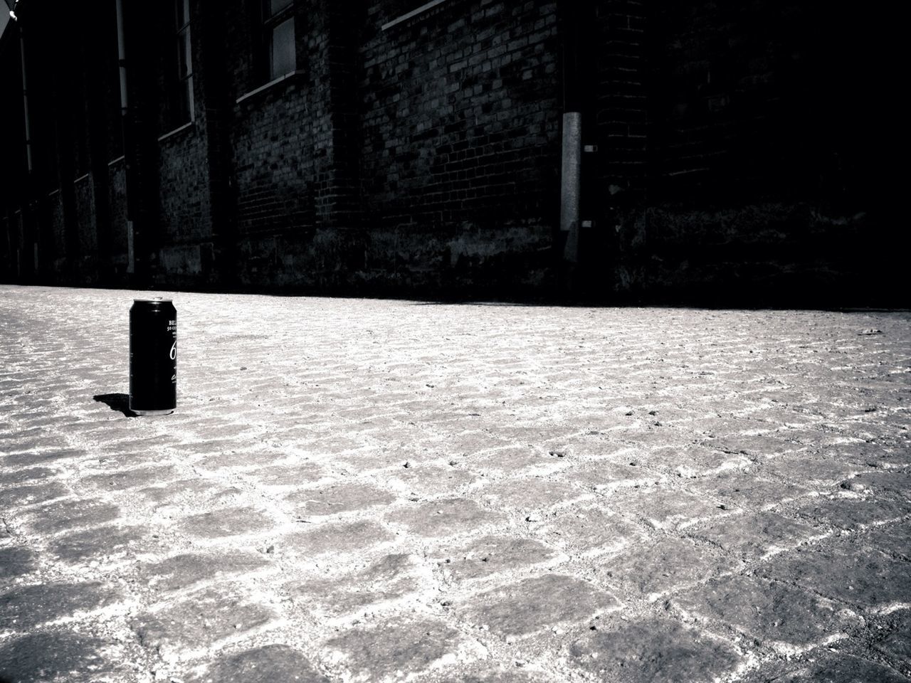 Beer can on cobblestone