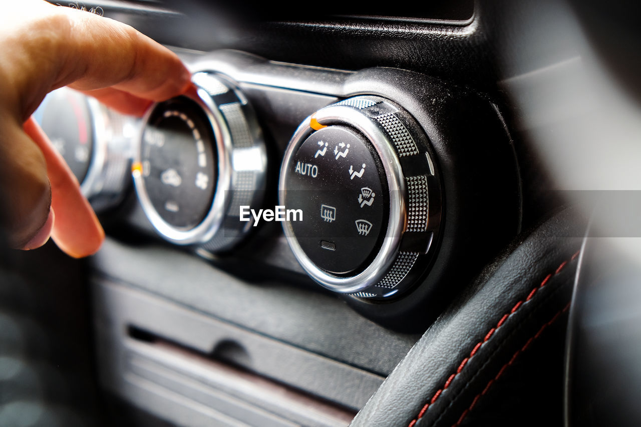 CLOSE-UP OF HUMAN HAND HOLDING CAR