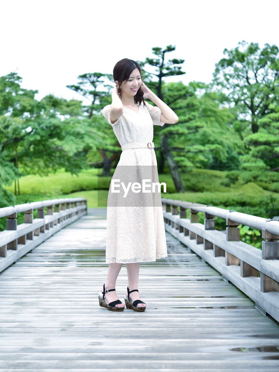 Full length of woman standing on footbridge