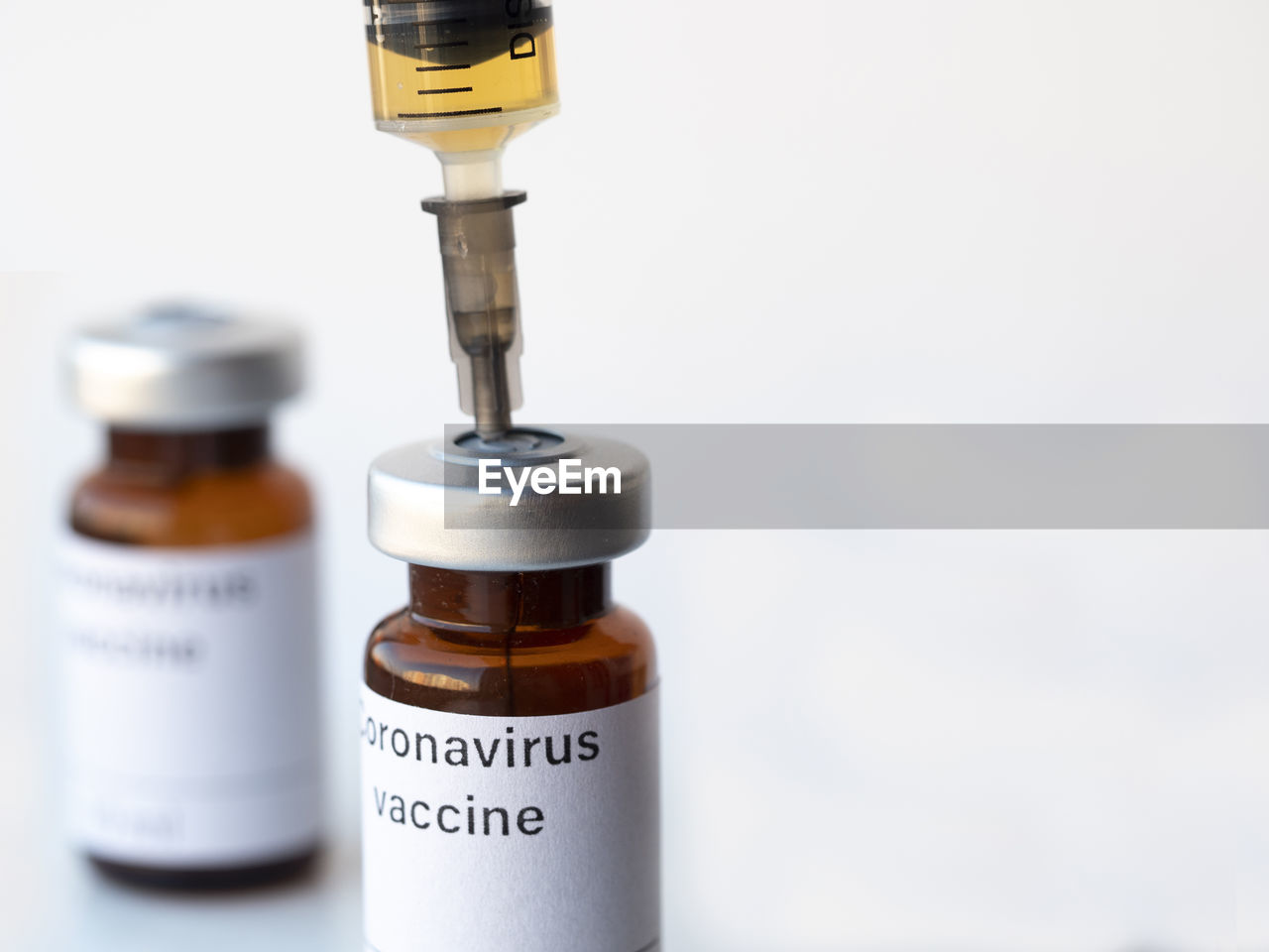 A syringe of fake covid-19 vaccine and vaccine vial