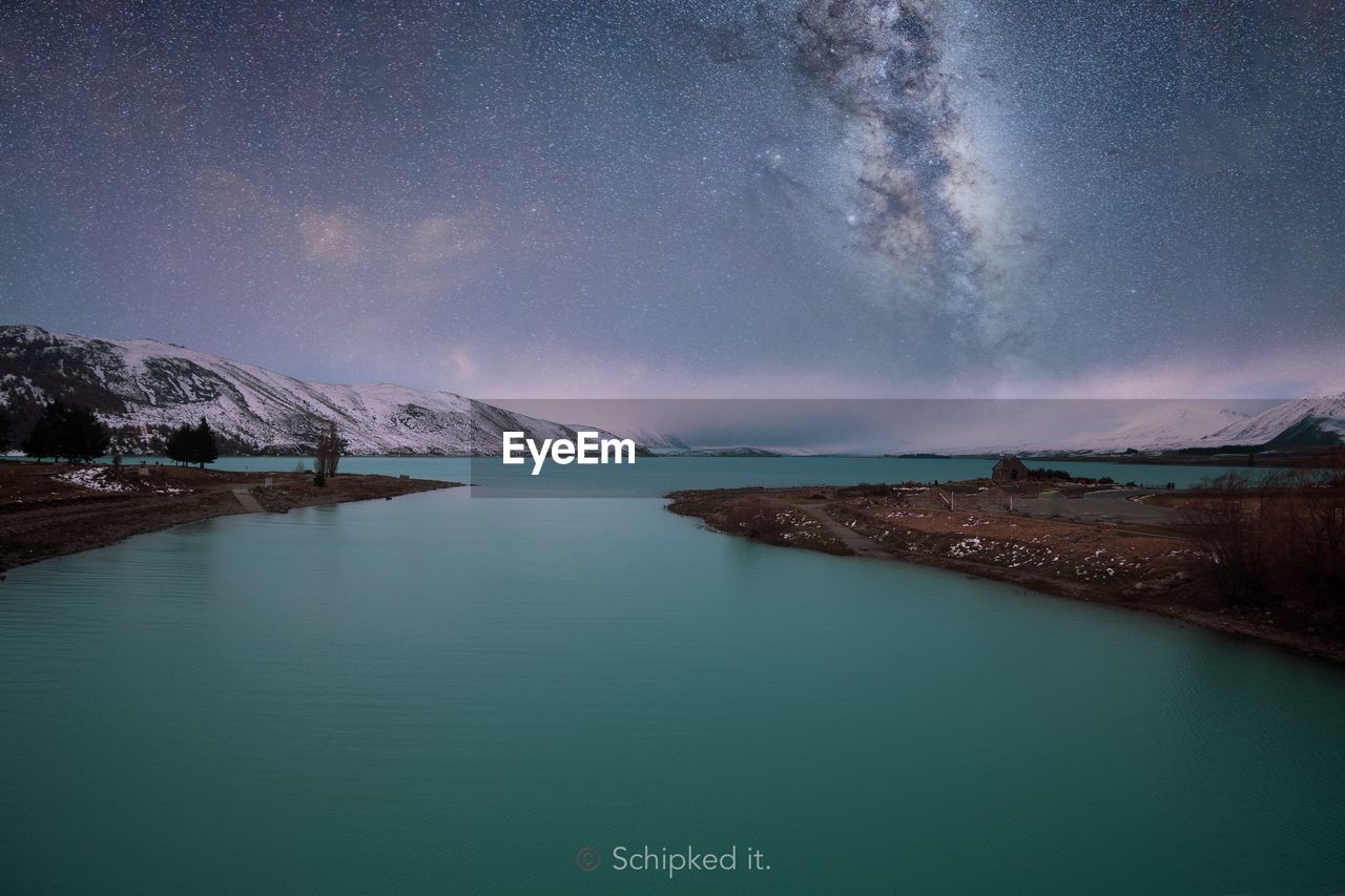 Scenic view of lake against sky at night