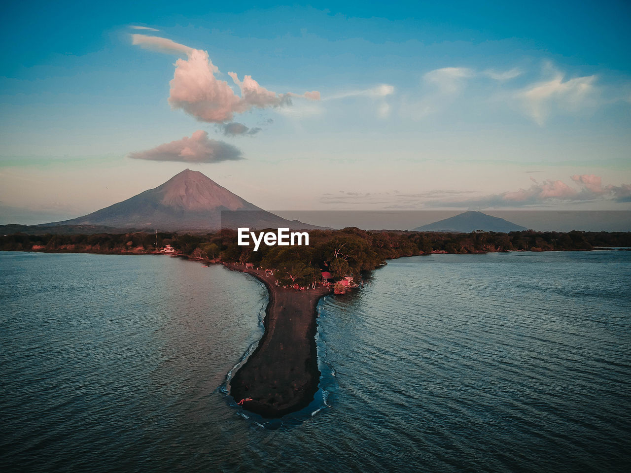 Scenic view of sea against sky and volcano