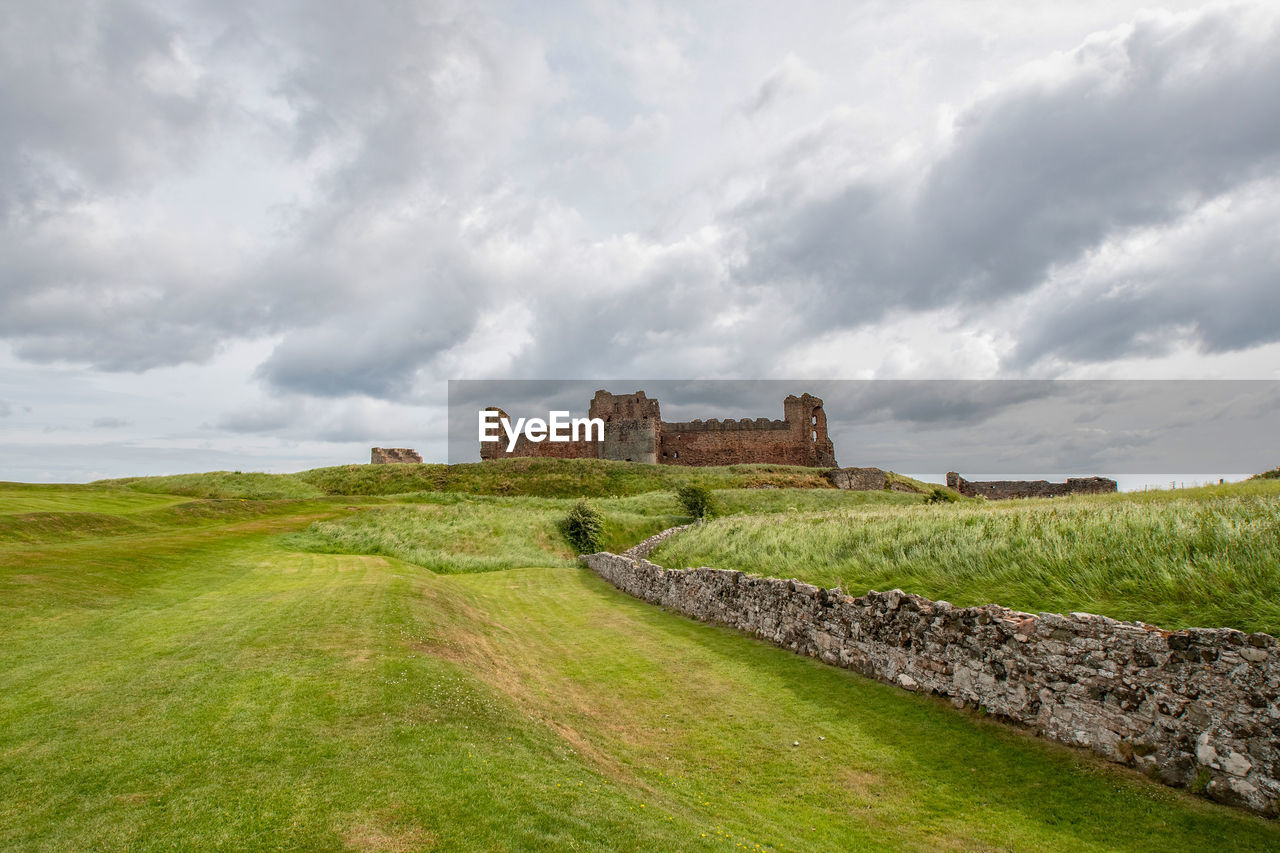 OLD RUIN ON LANDSCAPE AGAINST SKY