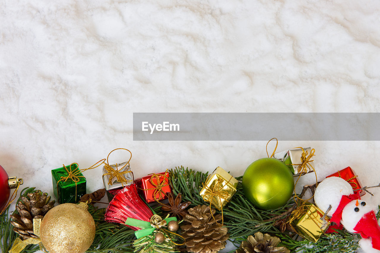 Directly above shot of christmas decorations on fake snow