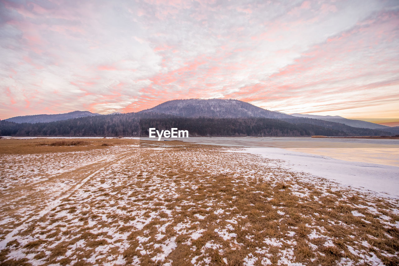 Scenic view of lake against sky during sunset