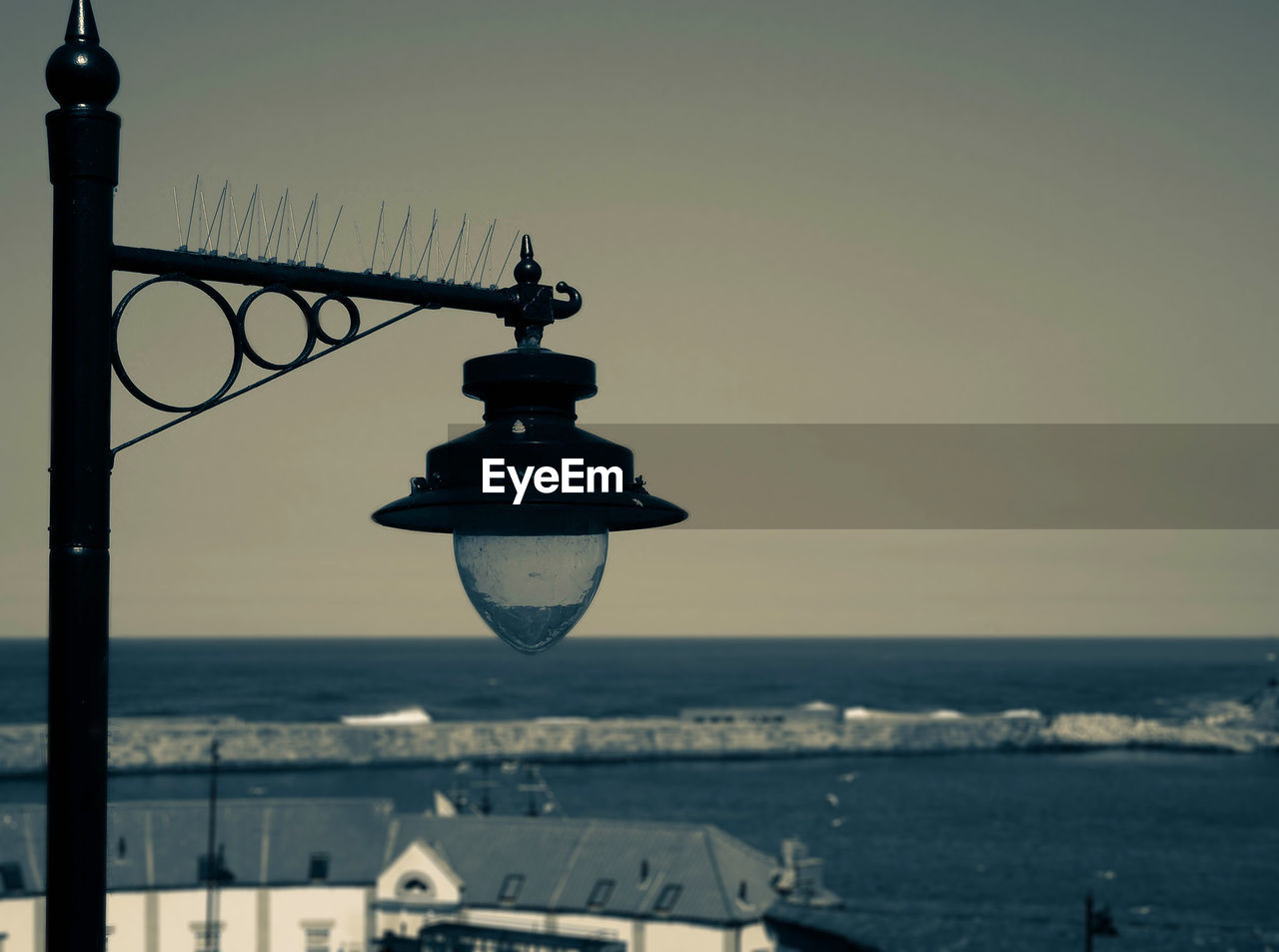 Street lamp against sea