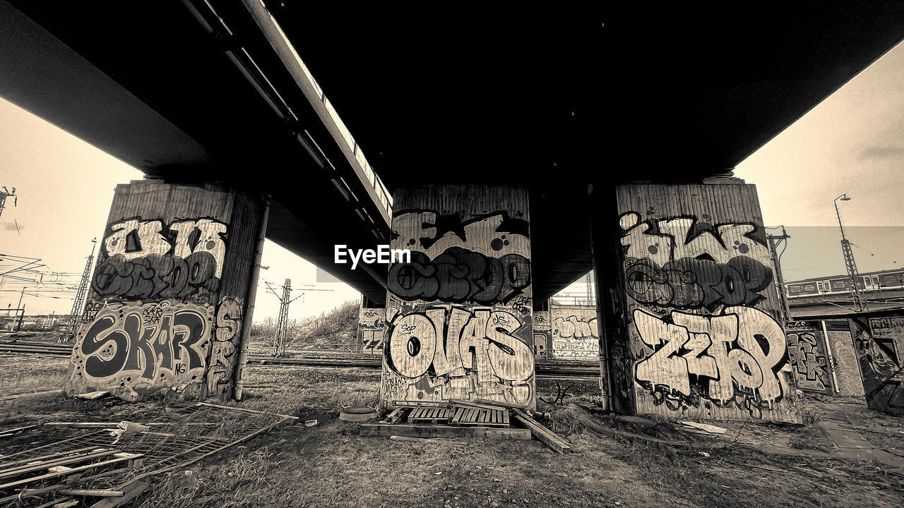 GRAFFITI ON BRIDGE AT RAILWAY STATION