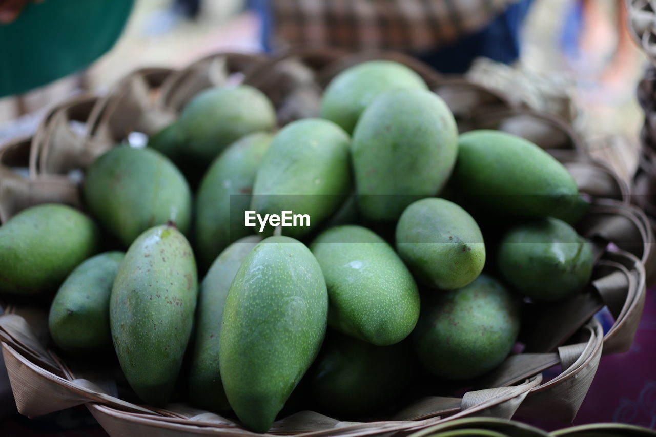 Close-up of fruits in basket at market stall