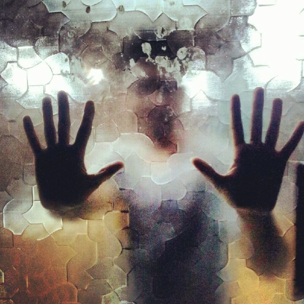 Man seen from frosted glass