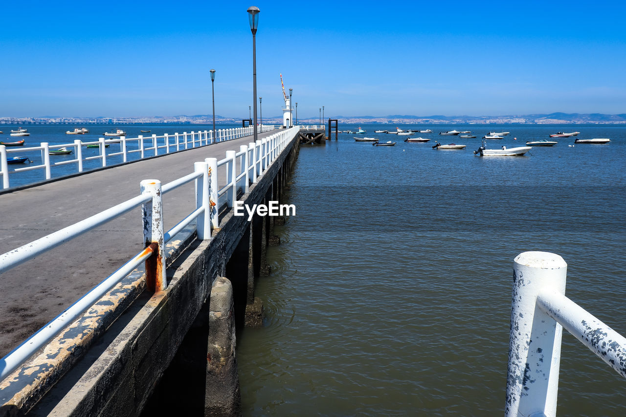 PIER OVER SEA AGAINST BLUE SKY