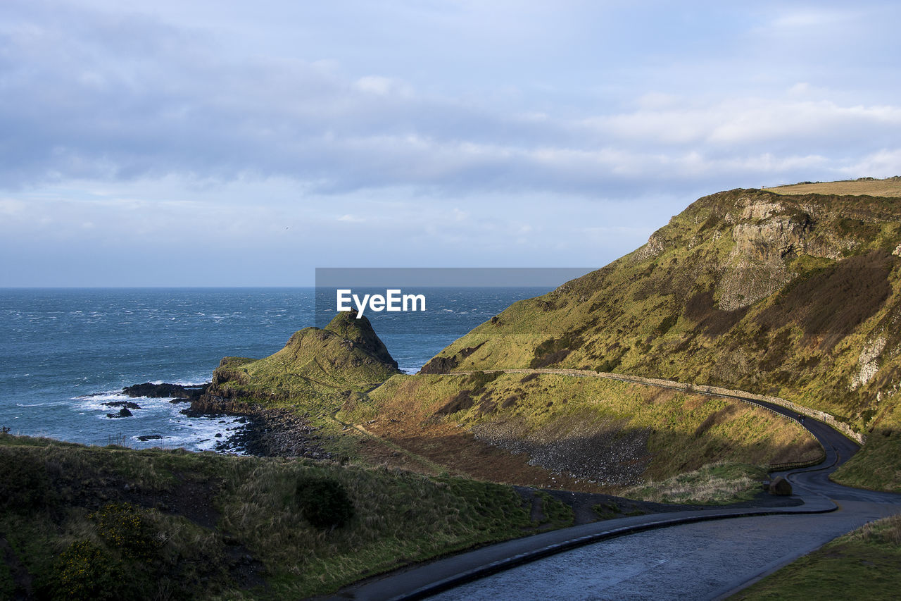 Road by sea against sky