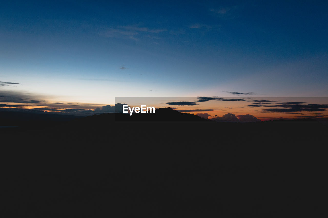 SILHOUETTE LANDSCAPE AGAINST SKY AT SUNSET