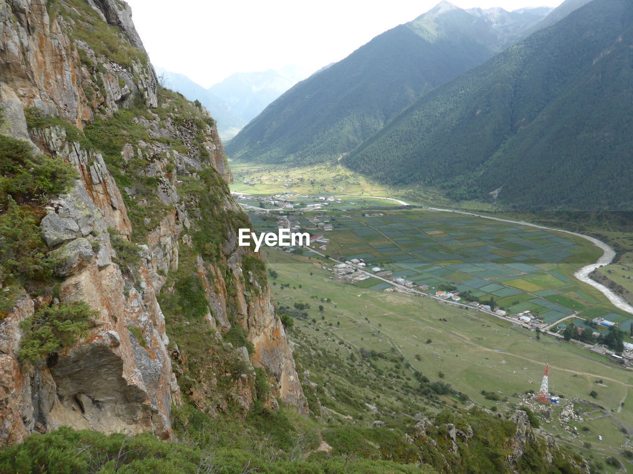 High angle view of land and mountains against sky