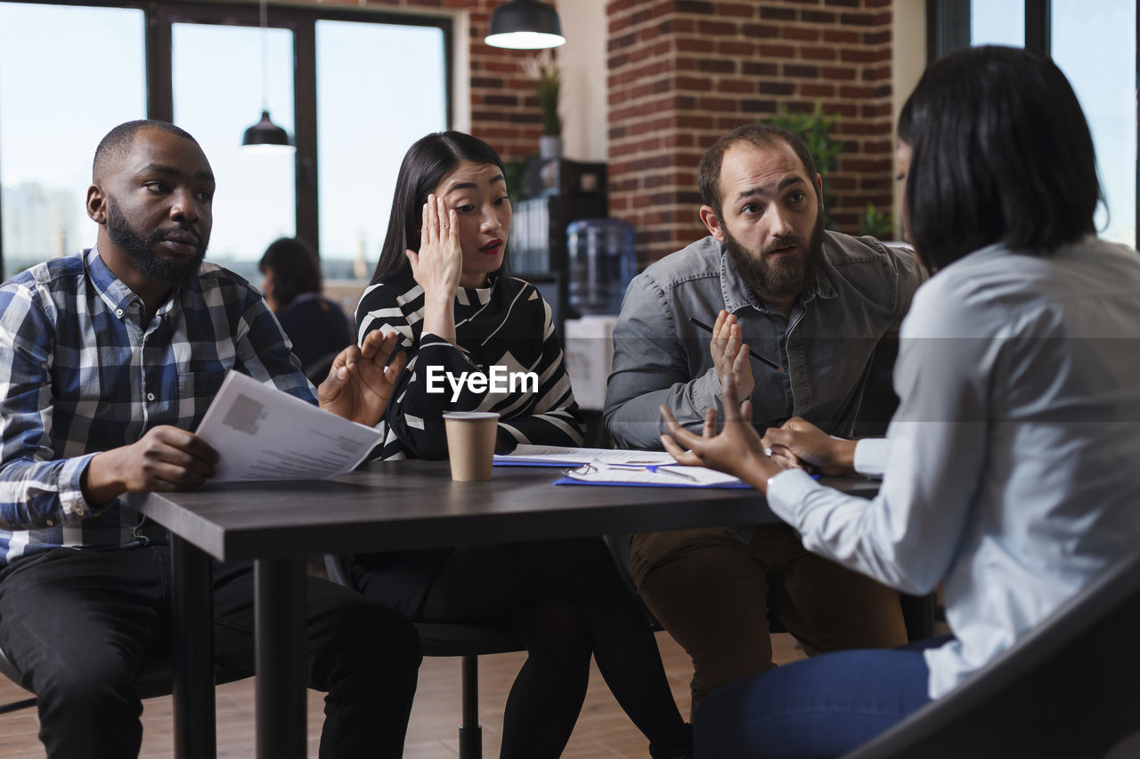 Business people conducting interview in office