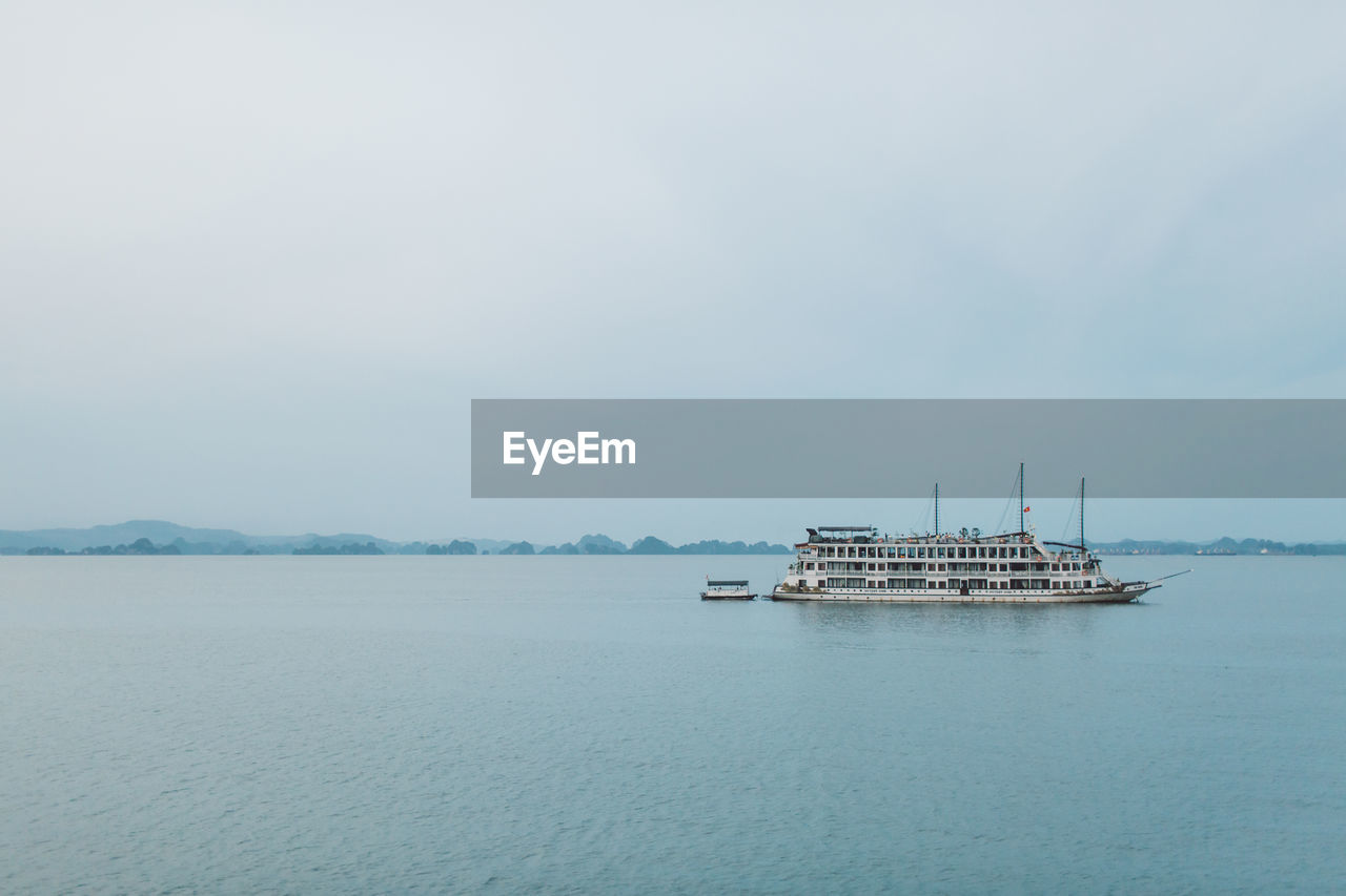 Ferry boat sailing on sea against sky