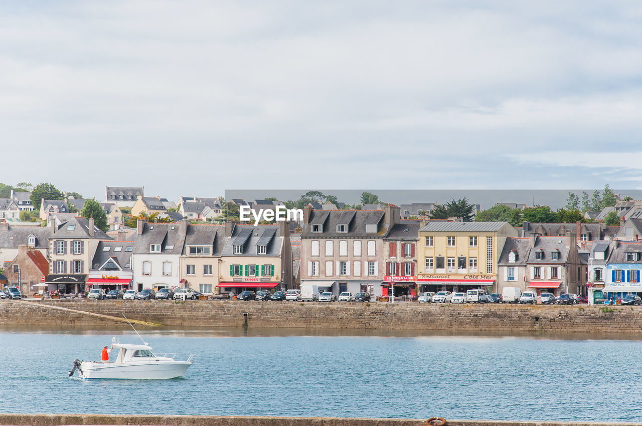 BUILDINGS BY SEA AGAINST SKY