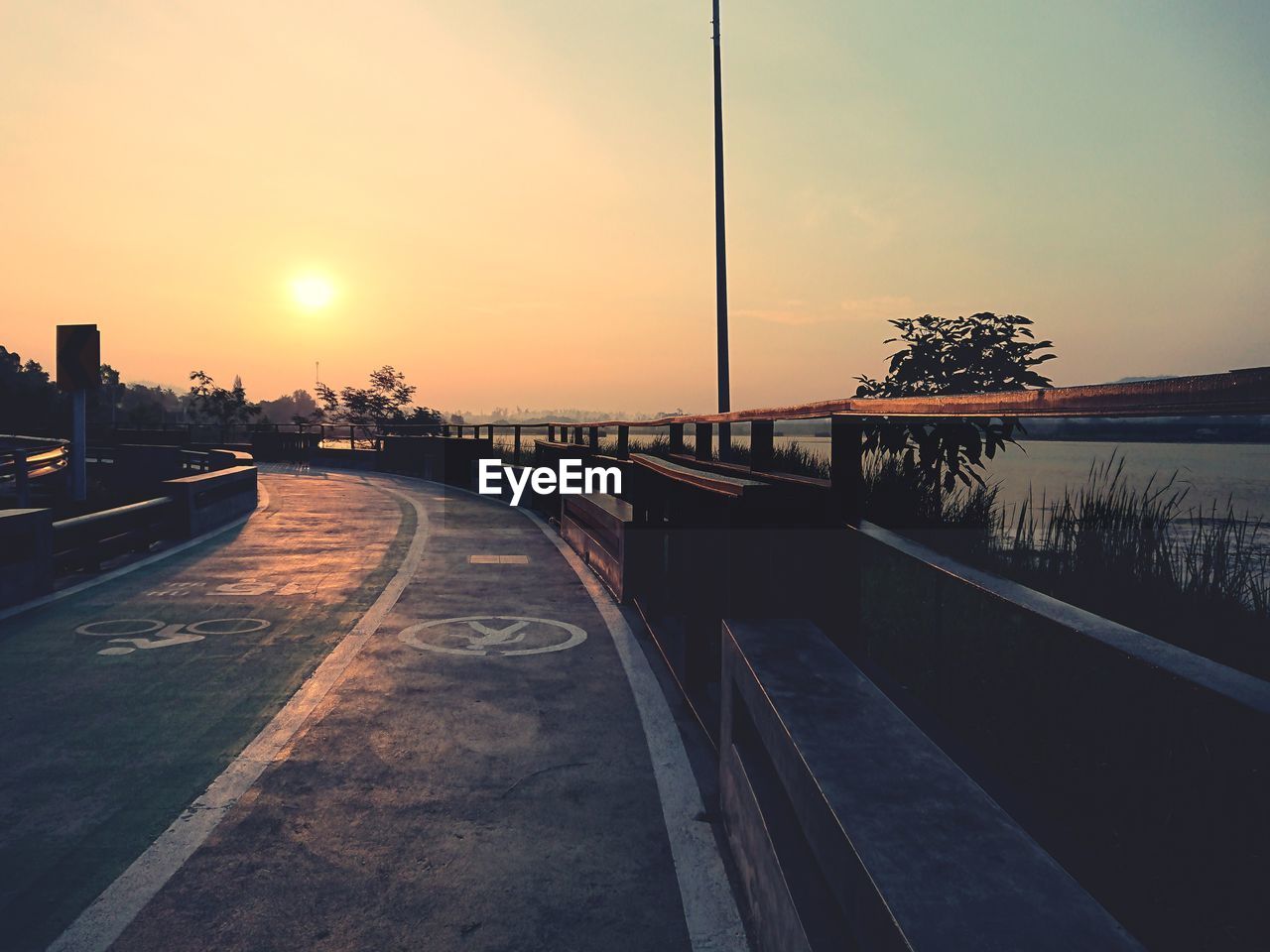 Scenic view of river against sky at sunset