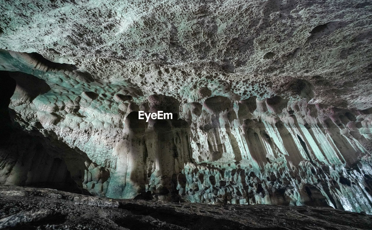 LOW ANGLE VIEW OF ROCKS IN CAVE