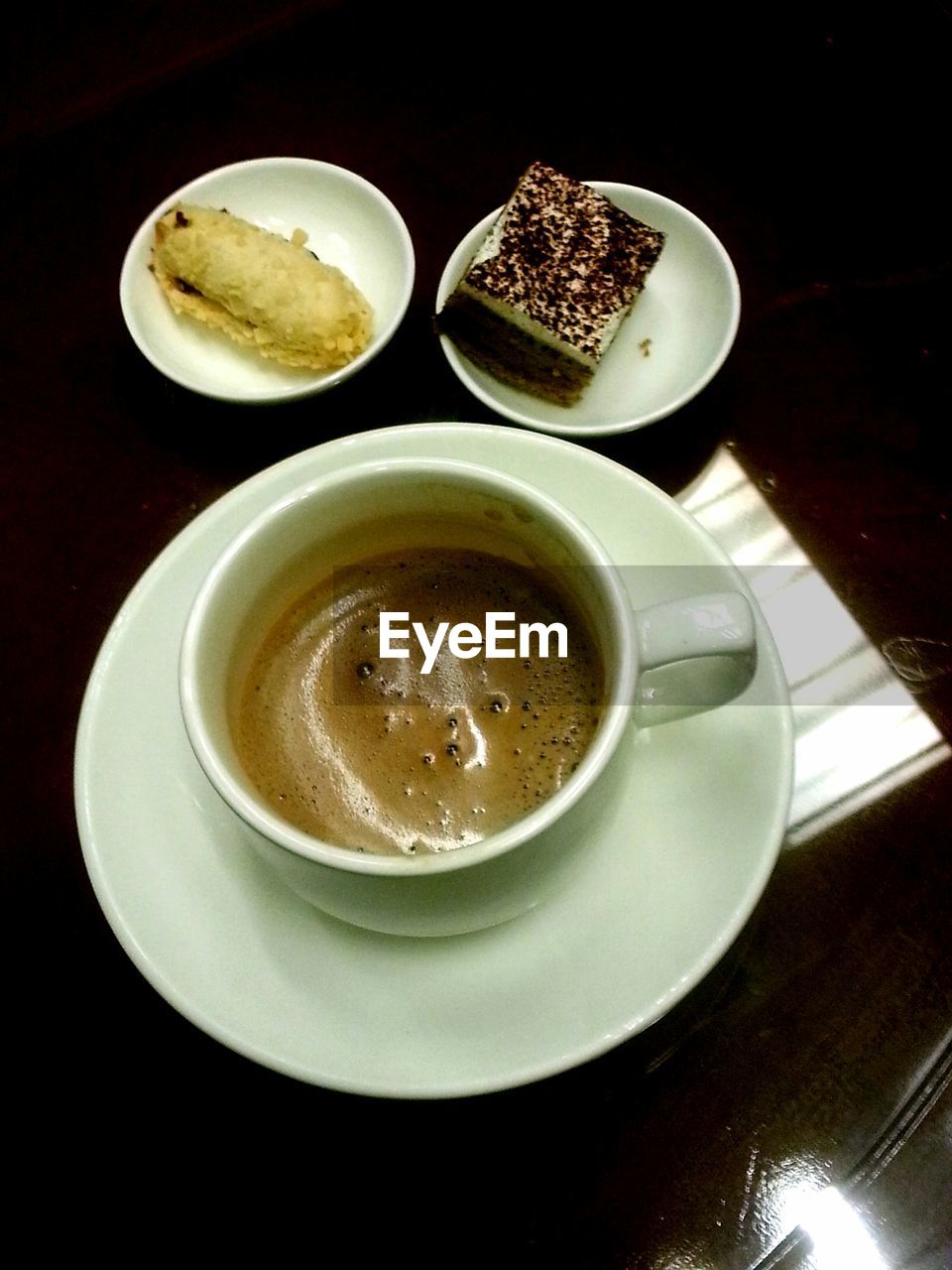 High angle view of coffee with cake on table