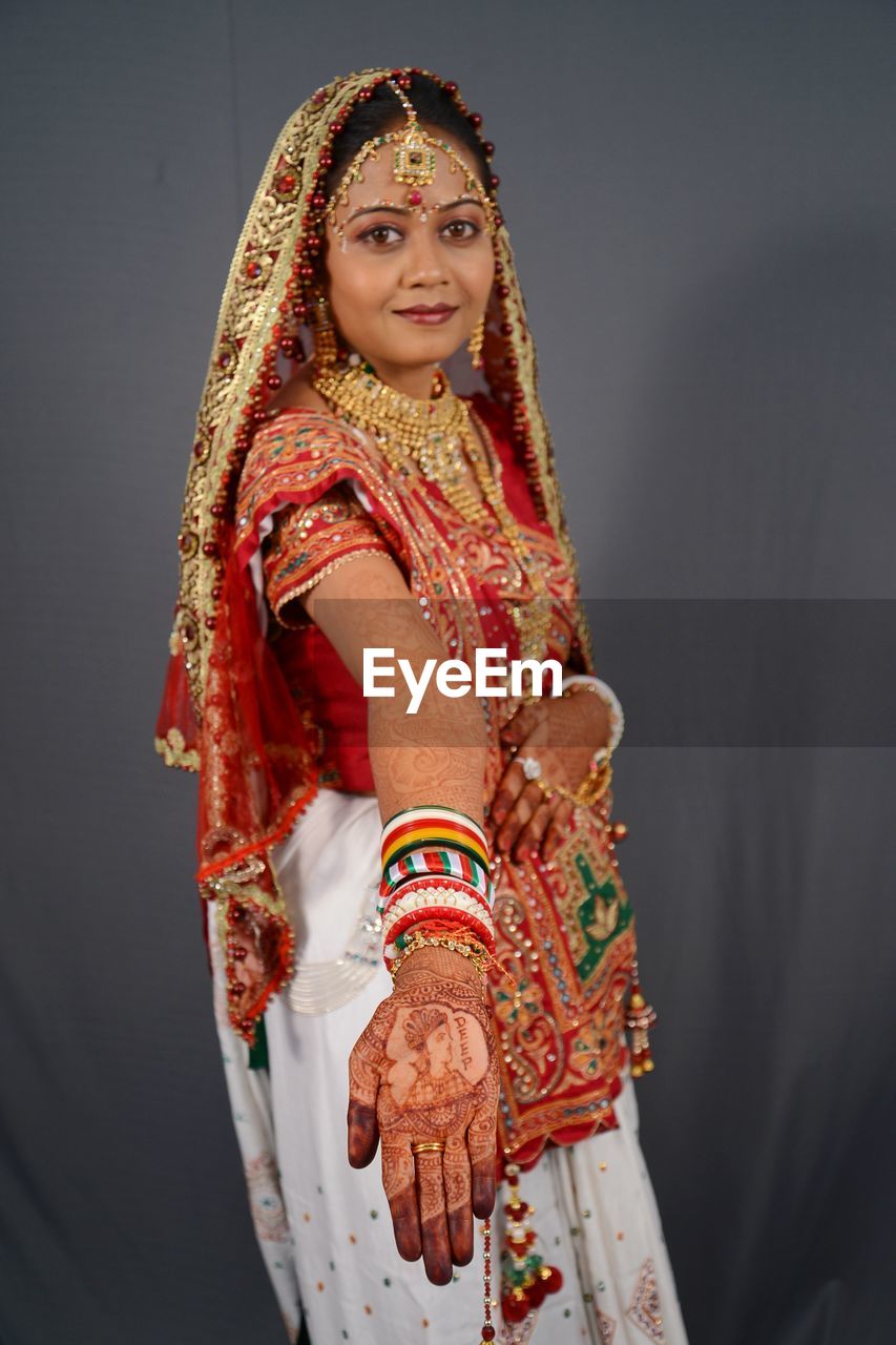 Portrait of smiling woman showing henna tattoo