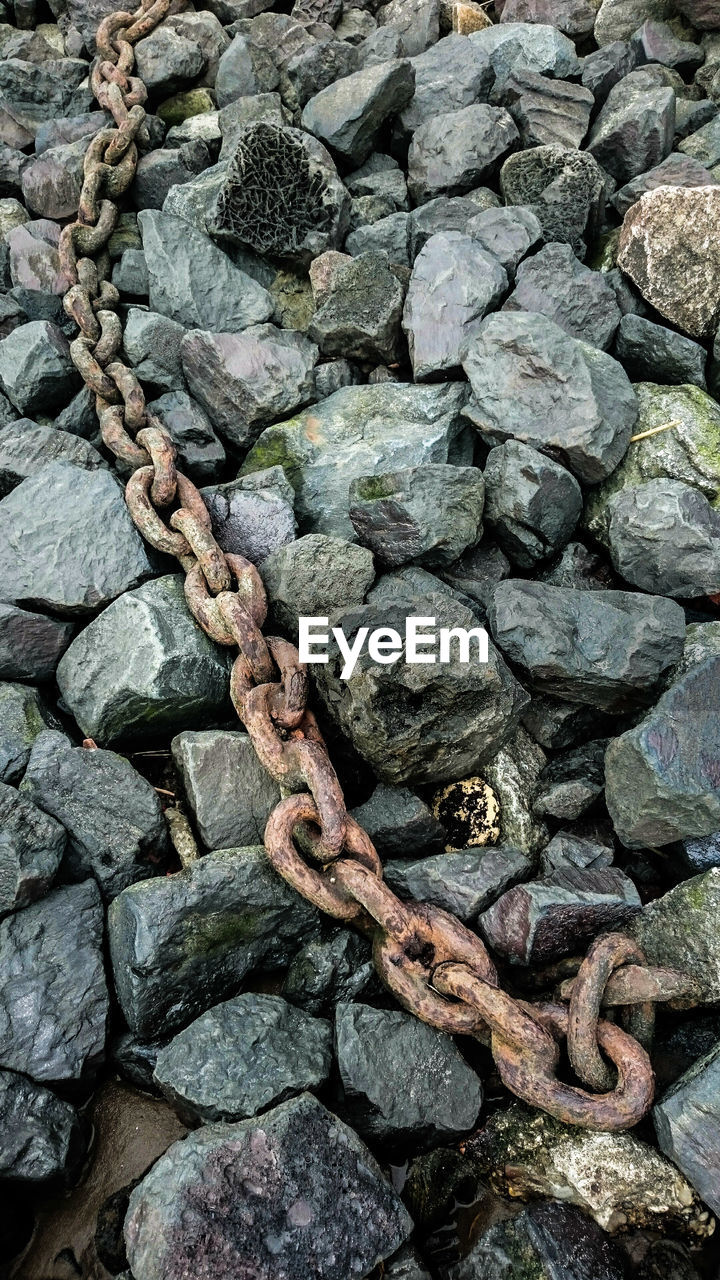 High angle view of chain on rocks