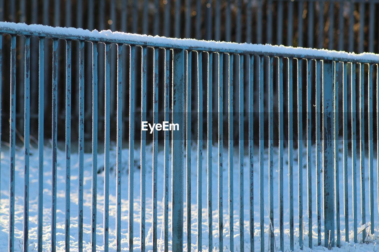 Close-up of frozen metallic railing during winter
