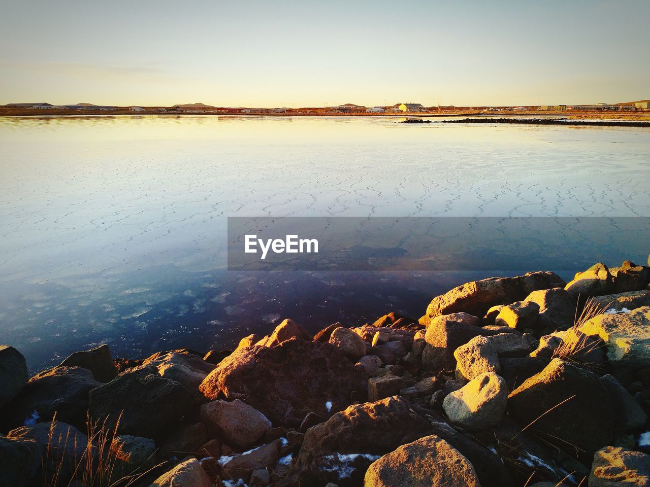 SCENIC VIEW OF LAKE AGAINST SKY DURING SUNSET