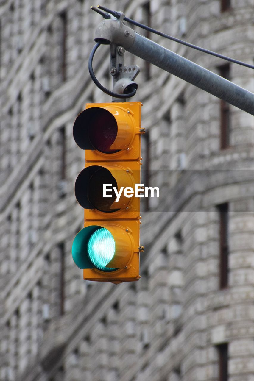 LOW ANGLE VIEW OF ILLUMINATED ROAD SIGNAL