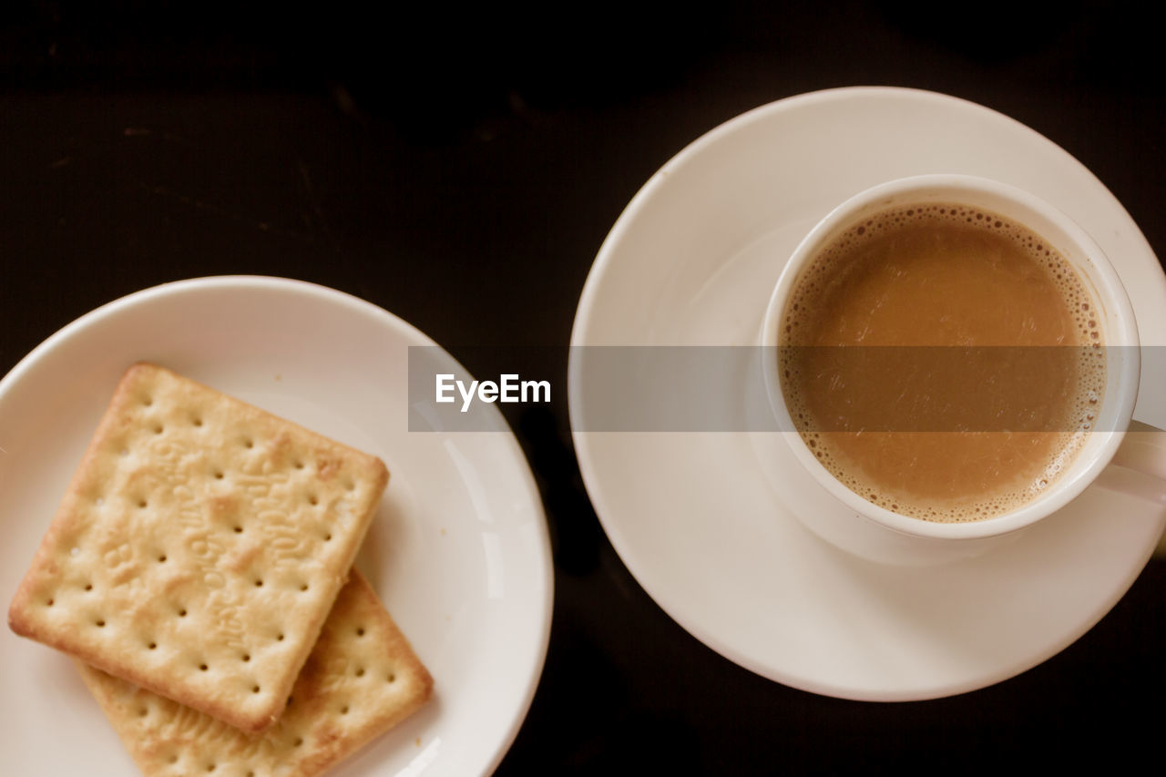 HIGH ANGLE VIEW OF COFFEE AND CUP ON BLACK TABLE