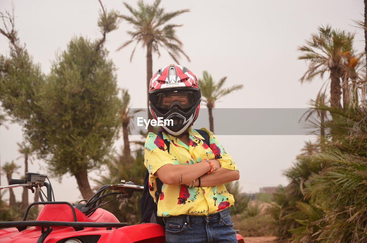 Girl riding motorcycle against sky