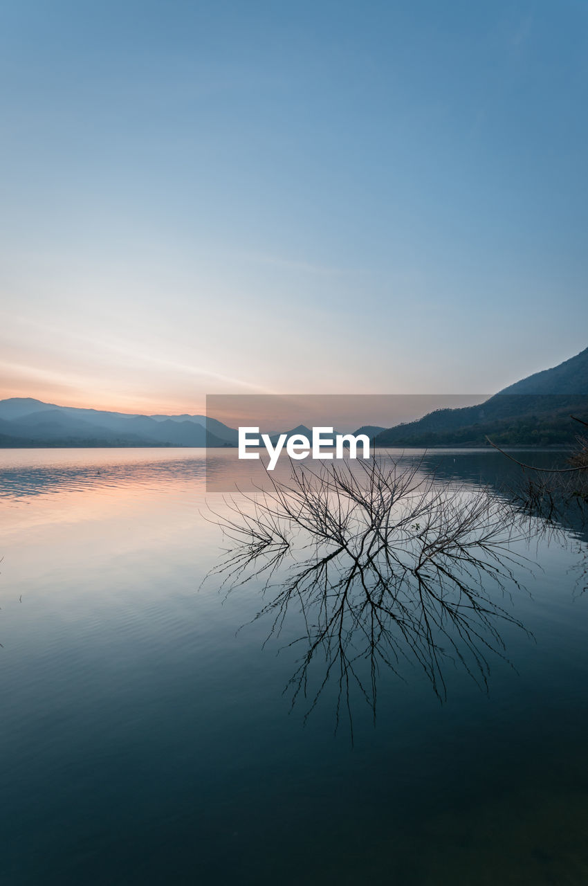 Scenic view of lake against sky during sunset